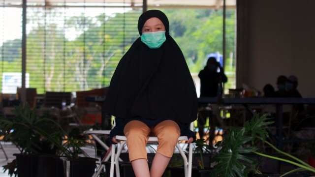 Aisyah Alusa (10), seorang pasien COVID-19 yang terpapar dari ibunya berada di Rumah Lawan COVID Serpong, Tangerang Selatan, Banten, Selasa (19/1) Foto: ANTARA FOTO/Muhammad Iqbal