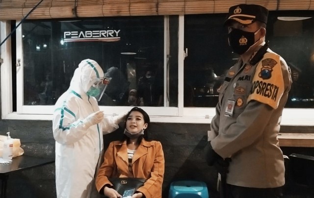 Aparat gabungan melakukan patroli skala besar selama masa PPKM di Kota Malang. Foto : Azmy.