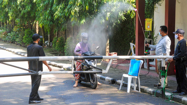 Warga disemprot disinfektan saat keluar dari Perumahan Griya Melati, Kelurahan Bubulak, Kota Bogor, Jawa Barat, Rabu (26/5/2021). Foto: Arif Firmansyah/ANTARA FOTO