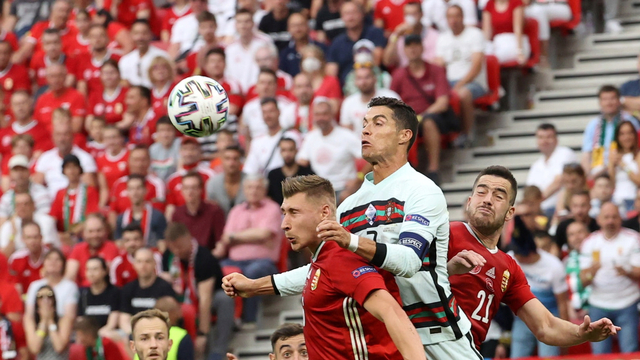 Pemain Portugal Cristiano Ronaldo beraksi dengan Pemain Hongaria Endre Botka dan Willi Orban pada laga Euro 2020 di Puskas Arena, Budapest, Hongaria, Selasa (15/6). Foto: Pool via REUTERS/Bernadett Szabo 