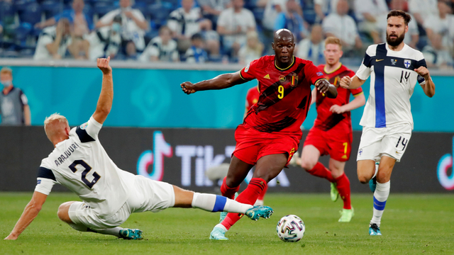 Pemain Belgia Romelu Lukaku beraksi dengan Pemain Finlandia Paulus Arajuuri di Stadion Saint Petersburg, Saint Petersburg, Rusia, Senin (21/6). Foto: Pool via Reuters/Maxim Shemetov