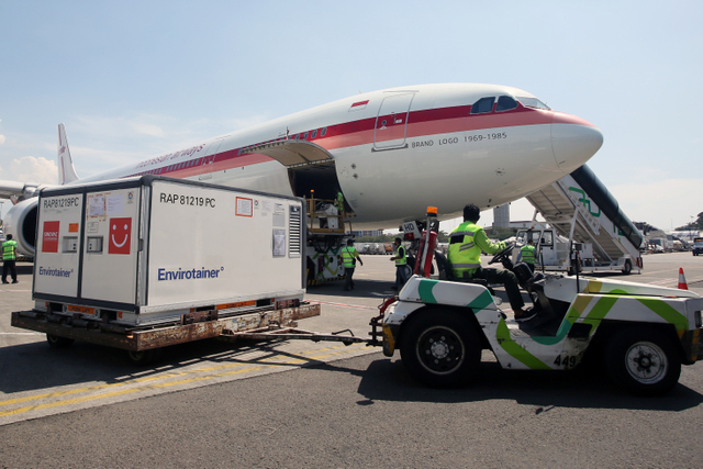 Pekerja melakukan bongkar muat Envirotainer berisi vaksin COVID-19 Sinovac setibanya dari Beijing di Terminal Cargo Bandara Soekarno Hatta, Tangerang, Banten, Senin, (12/7). Foto: Muhammad Iqbal/ANTARA FOTO