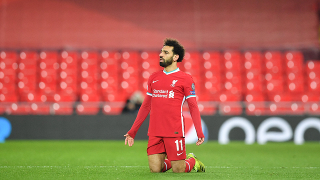 Gelandang Liverpool Mesir Mohamed Salah bereaksi saat pertandingan sepak bola leg kedua perempat final Liga Champions UEFA antara Liverpool dan Real Madrid di Anfield di Liverpool, Inggris barat laut pada 14 April 2021. Foto: PAUL ELLIS / AFP