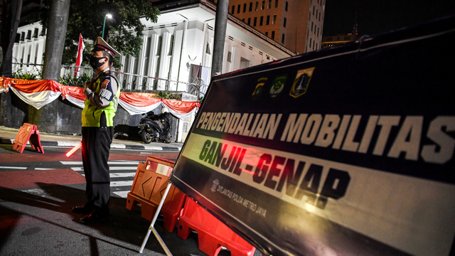 Petugas kepolisian berjaga di pos pemeriksaan ganjil genap selama perpanjangan PPKM level 4 di Jalan MH Thamrin, Jakarta, Minggu (15/8/2021). Foto: Hafidz Mubarak A/ANTARA FOTO