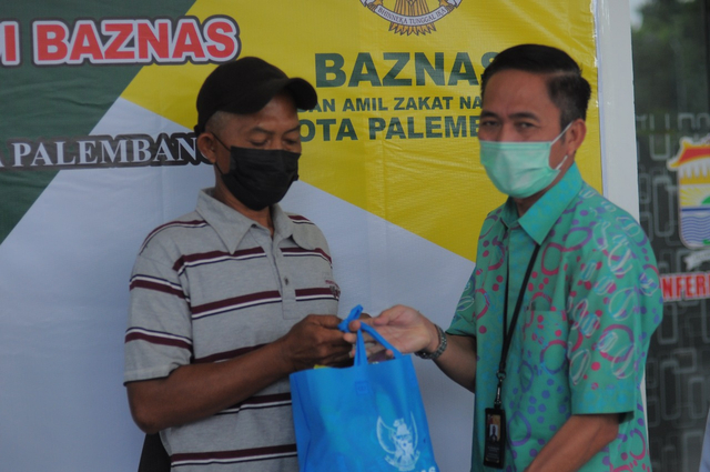 Sekda Palembang, Ratu Dewa, menyerahkan simbolis santuan untuk para penggali kubur di Palembang. Foto: Istimewa