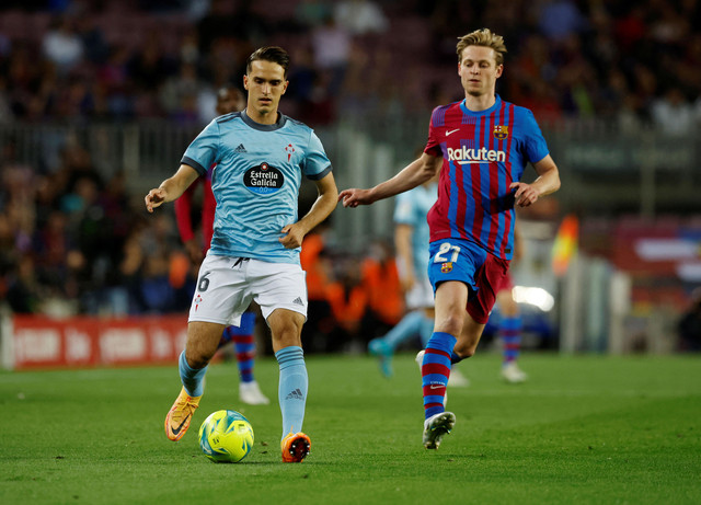 Frenkie de Jong dari FC Barcelona duel dengan Denis Suarez dari Celta Vigo saat pertandingan LaLiga di Camp Nou, Barcelona, Spanyol. Foto: Albert Gea/Reuters