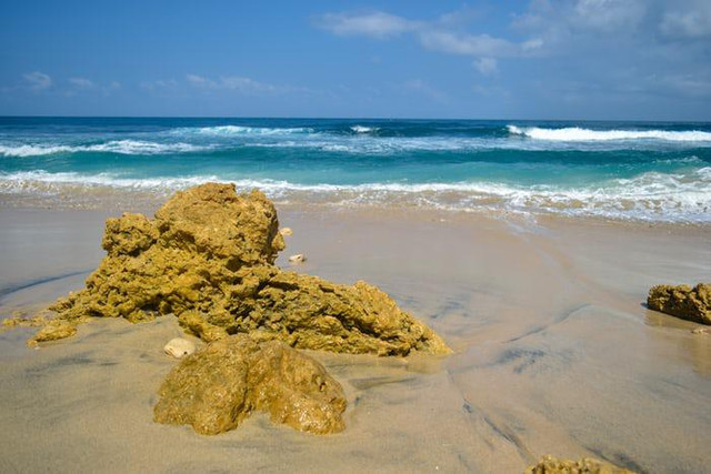 harga tiket masuk pantai 3 warna. sumber foto : unsplash/batu cokelat di pantai