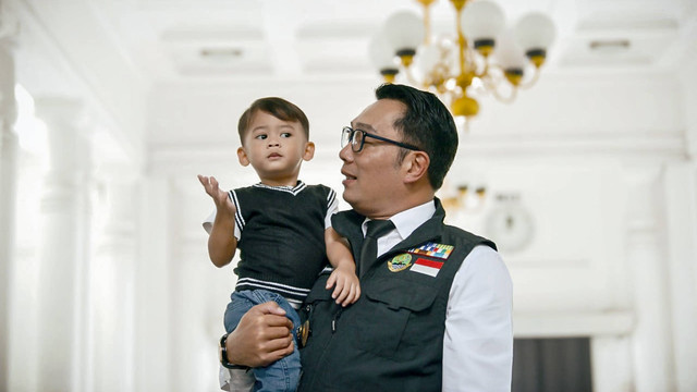 Gubernur Jawa Barat Ridwan Kamil menggendong putra bungsunya Arkana Aidan Misbach di kawasan Gedung Sate, Kota Bandung, Senin (6/6/2022). Foto: Dok. Istimewa