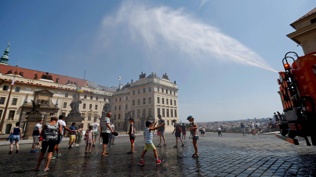 Sejumlah warga berkumpul untuk menikmati semprotan air untuk mendinginkan diri di tengah ancaman gelombang panas di Praha, Republik Ceko, Rabu (20/7/2022). Foto: David W Cerny/Reuters