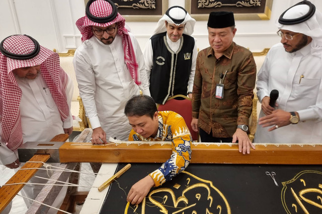 Dirjen Penyelenggaraan Haji dan Umrah, Prof Hilman Latief, menyulam kiswah.
 Foto: Muhammad Iqbal/kumparan