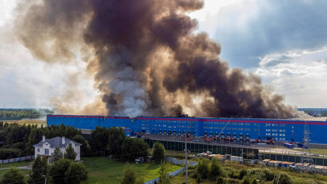 Asap mengepul di atas gudang perusahaan e-commerce Ozon yang terbakar di Distrik Istrinsky di wilayah Moskow, Rusia, Rabu (3/8/2022). Foto: Maxim Shemetov/Reuters