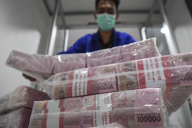 Petugas menata uang tunai sebelum didistribusikan melalui kantor cabang dan mesin ATM di Pooling Cash Plaza Mandiri, Jakarta, Kamis (8/9/2022). Foto: M Risyal Hidayat/Antara Foto