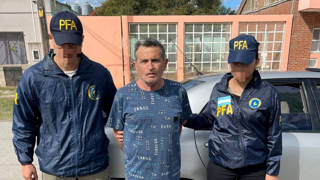 Polisi mengawal Carmine Alfonso Maiorano setelah dia ditahan di Guernica, Argentina, dalam gambar selebaran tidak bertanggal yang disediakan oleh Polisi Federal Argentina, Senin (31/10/2022). Foto: Policia Federal Argentina/Handout via REUTERS