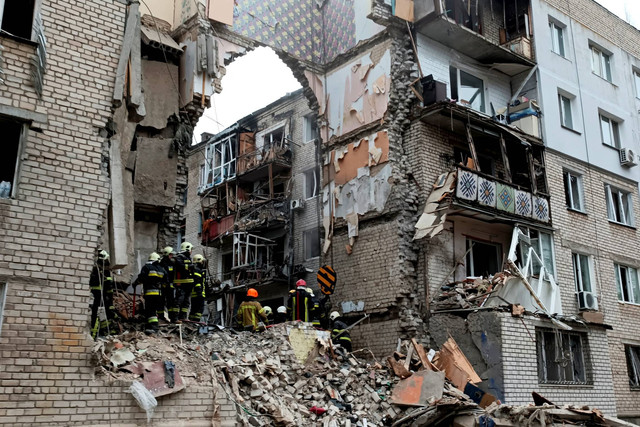 Tim penyelamat bekerja di lokasi bangunan tempat tinggal yang rusak parah akibat serangan rudal Rusia, di Mykolaiv, Ukraina, Jumat (11/11/2022). Foto: Viktoria Lakezina/REUTERS