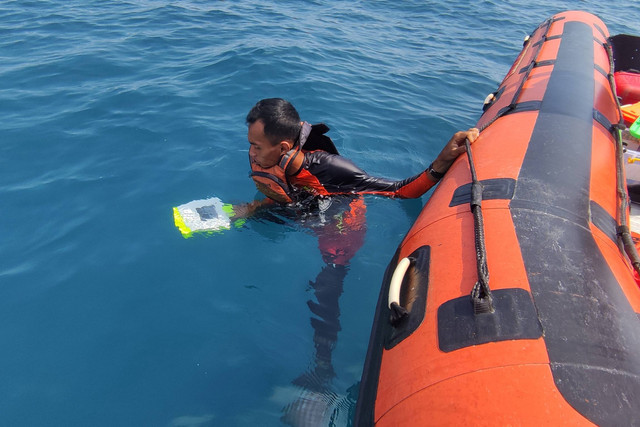 Seorang anggota Tim SAR gabungan melakukan evakuasi serpihan dari helikopter milik Polri NBO-105 yang jatuh di perairan Manggar, Belitung Timur, Kepulauan Bangka Belitung, Selasa (29/11/2022). Foto: Kantor SAR Pangkal Pinang/Handout ANTARA