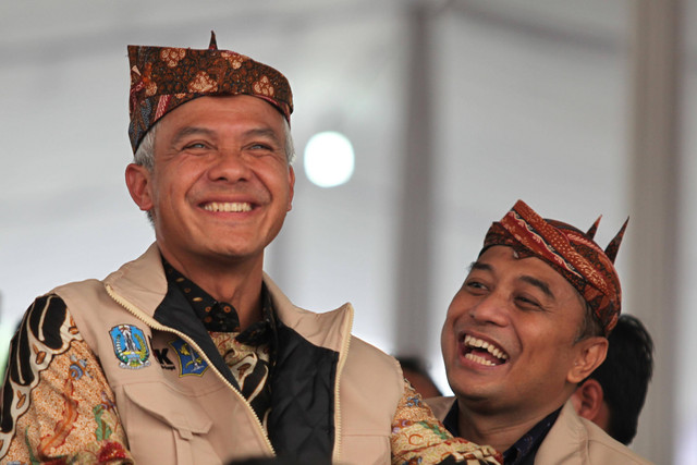 Gubernur Jawa Tengah Ganjar Pranowo (kiri) didampingi Wali Kota Surabaya Eri Cahyadi (kanan) menghadiri Road to Hakordia (Hari Antikorupsi Sedunia) di Alun-Alun Surabaya, Jawa Timur, Kamis (1/12/2022). Foto: Didik Suhartono/ANTARA FOTO