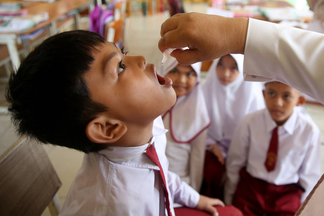 Petugas memberi vaksin polio kepada pelajar Sekolah Dasar (SD) Negeri 43 seusai pencanangan Sub Pekan Imunisasi Nasional (PIN) Polio oleh Menteri Kesehatan Budi Gunadi Sadikin di Banda Aceh, Aceh, Senin (5/12/2022). Foto: Irwansyah Putra/ANTARA FOTO