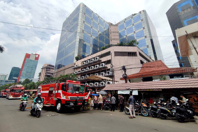 Petugas pemadam kebakaran bekerja di lokasi kebakaran di Gedung Kantor Kemenkumham, Jakarta, Kamis (8/12/2022). Foto: Jamal Ramadhan/kumparan