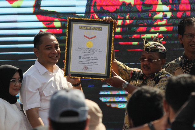 Wali Kota Surabaya Eri Cahyadi (kedua kiri) didampingi Wakil Wali Kota Surabaya Armuji (kedua kanan) menunjukkan piagam penghargaan dari MURI saat Tari Remo Massal di Jembatan Suroboyo, Surabaya, Jawa Timur, Minggu (18/12/2022). Foto: Didik Suhartono/ANTARA FOTO