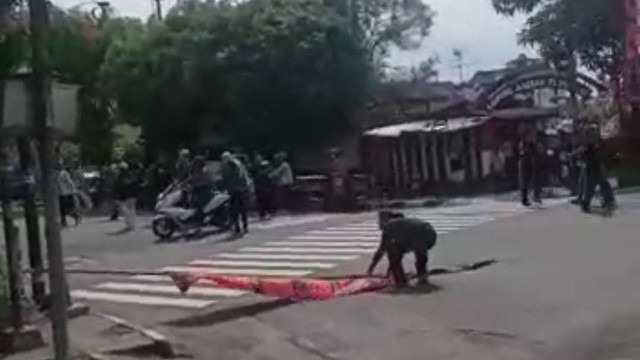 Seorang warga yang tengah mencopoti umbul-umbul PDIP. Foto: istimewa