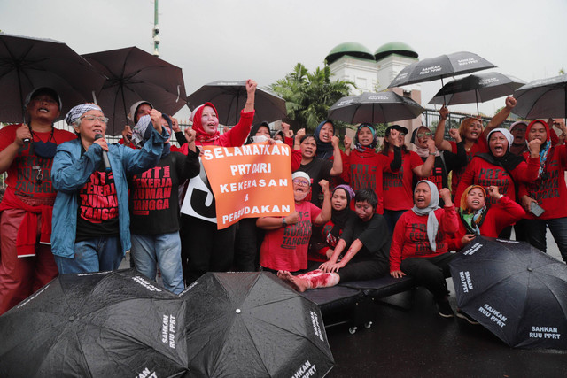 Sejumlah perempuan yang tergabung dalam Koalisi Sipil untuk RUU PRT menggelar aksi di depan gerbang Parlemen RI, Jalan Gatot Subroto, Jakarta, Rabu (1/2/2023). Foto: Jamal Ramadhan/kumparan