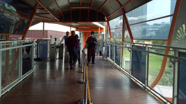 Gate pembatas yang memisahkan pejalan kaki biasa dengan pejalan yang hendak menuju angkutan umum di Skywalk Kebayoran Lama. Foto: Ananta Erlangga/kumparan