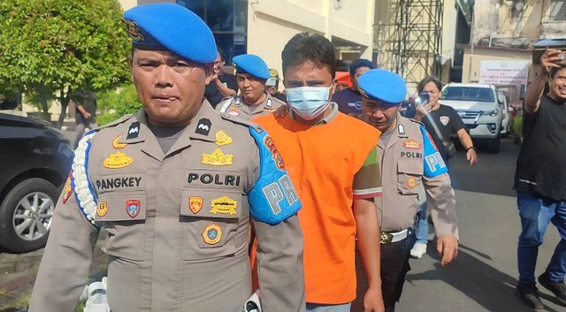 Polisi saat mengawal MB alias Marlon, seorang terduga pelaku kekerasan seksual terhadap Icha, anak usia 10 tahun yang meninggal tahun 2021 lalu