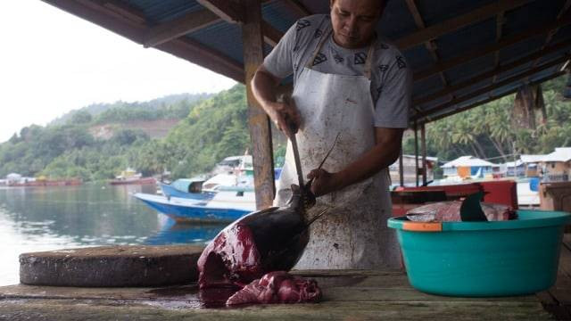 Salah satu pedagang sedang membelah ikan di pasar Bacan, Halmahera Selatan. Maluku Utara. Foto: Faris Bobero/cermat