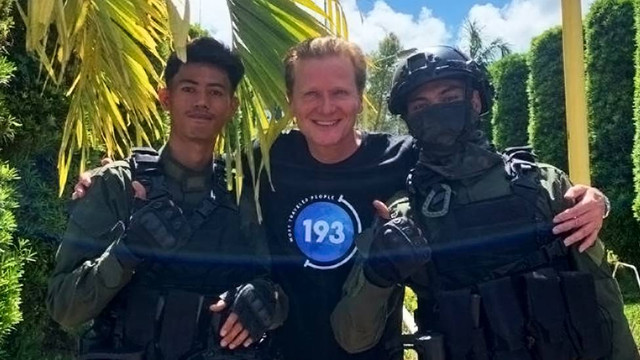 Kari-Matti Valtari (tengah) bersama dua aparat kepolisian.
