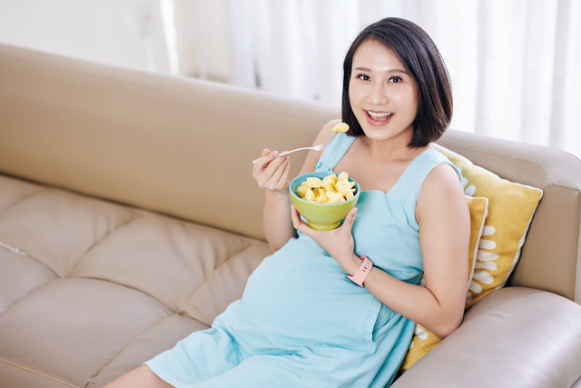 Ilustrasi ibu hamil makan buah. Foto: Dragon Images/Shutterstock