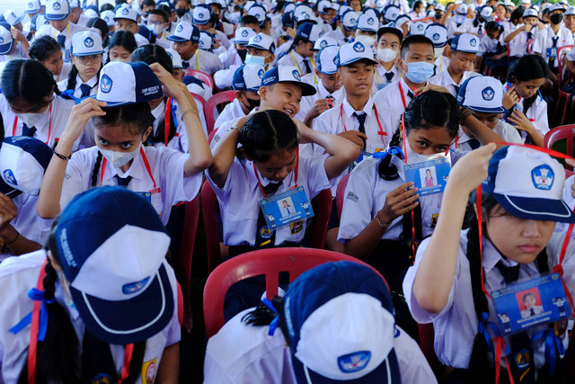 Peserta didik baru memasang atribut saat mengikuti Masa Pengenalan Lingkungan Sekolah (MPLS) tahun ajaran 2023/2024 di SMP Negeri 14 Denpasar, Bali, Senin (10/7/2023). Foto: ANTARA FOTO/Nyoman Hendra Wibowo