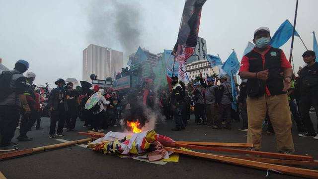 Massa buruh mulai bakar-bakaran di kawasan Patung Kuda, Jakarta, Kamis (10/8/2023). Foto: Jonathan Devin/kumparan