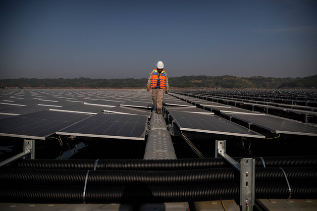 Teknisi memeriksa solar panel pada proyek PLTS Terapung di Waduk Cirata, Kabupaten Purwakarta, Jawa Barat, Selasa (26/9/2023). Foto: Jamal Ramadhan/kumparan