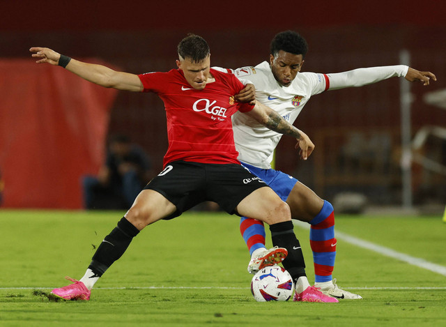 Duel Giovanni Gonzalez dengan Alejandro Balde saat Real Mallorca vs Barcelona dalam laga pekan ketujuh Liga Spanyol 2023/24 di Estadi Mallorca Son Moix, Rabu (27/9/2023) dini hari WIB. Foto: REUTERS/Albert Gea