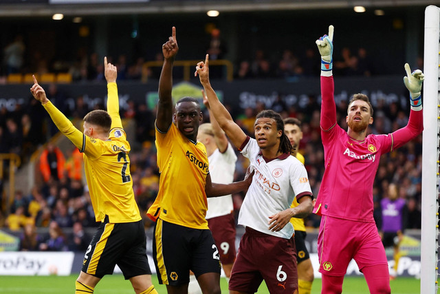 Pemain Manchester City Nathan Ake mengajukan banding bersama pemain Wolverhampton Wanderers Toti dan Jose Sa di Stadion Molineux, Wolverhampton, Inggris, Sabtu (30/9/2023). Foto: Hannah McKay/REUTERS
