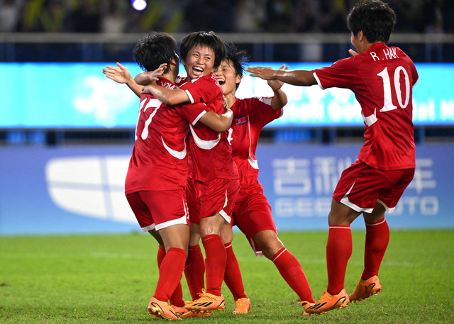 Kim Kyong Yong (kiri) dari Korea Utara merayakan golnya bersama rekan satu timnya saat perebutan medali emas sepak bola putri antara Jepang dan Korea Utara pada Asian Games 2022 di Hangzhou di provinsi Zhejiang timur Tiongkok pada 6 Oktober 2023. Foto: Jung Yeon-je / AFP