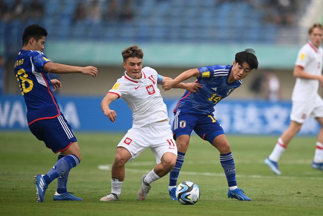 Pemain Timnas Jepang Gaku Nawata (kanan) berusaha menghalangi pemain Timnas Polandia Krzysztof Kolanko (tengah) saat pertandingan fase Grup D Piala Dunia U-17 2023 di Stadion Si Jalak Harupat, Kabupaten Bandung, Jawa Barat, Sabtu (11/11/2023). Foto: Wahyu Putro A/ANTARA FOTO