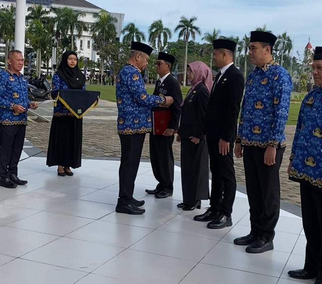 Pj Gubernur Kalbar Saat Menyematkan Tanda Anugerah Satyalancana Karya Satya. Foto: Yulia Ramadhiyanti/Hi!Pontianak