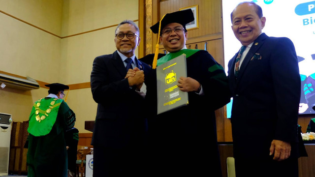 Ketua Umum PAN Zulkifli Hasan (kiri) memberikan selamat kepada Direktur Eksekutif Indikator Politik Indonesia, Burhanuddin Muhtadi (tengah) yang dikukuhkan sebagai Guru Besar Ilmu Politik UIN Syarif Hidayatullah Jakarta dalam Sidang Senat Terbuka, Rabu (29/3). Foto: Dok. Istimewa