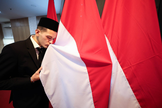 Justin Hubner mencium bendera Merah Putih usai ucap sumpah WNI di Kanwil Kemenkumham DKI Jakarta pada Rabu (6/12/2023). Foto: Dok. PSSI