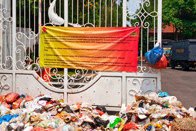 Aksi demonstrasi dengan membawa gerobak dan mobil berisi sampah lalu ditumpahkan di depan Pendopo Delta Wibawa, kantor Bupati Sidoarjo, Rabu (20/12/2023). Foto: Dok. Istimewa