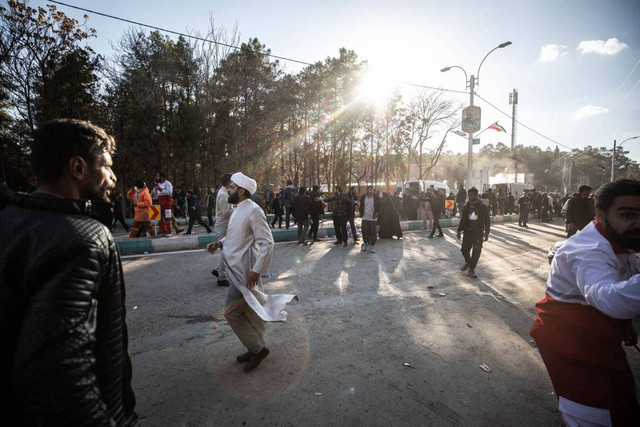 Orang-orang berpencar di dekat lokasi di mana dua ledakan berturut-turut menghantam kerumunan saat perayaan dua tahun kematian Qassem Soleimani di dekat Masjid Saheb al-Zaman di kota Kerman, Iran, Rabu (3/1/2024). Foto: MEHR NEWS / AFP