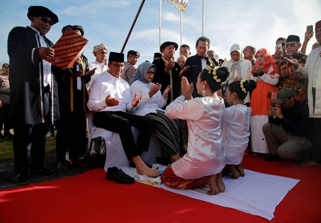 Calon presiden nomor urut 1 Anies Baswedan (kiri, duduk) didampingi istrinya Fery Farhati Ganis disambut dengan adat kesultanan Ternate sebelum memasuki Kedaton Kesultanan Ternate, Kota Ternate, Maluku Utara, Jumat (26/1/2024). Foto: Andri Saputra/ANTARA FOTO