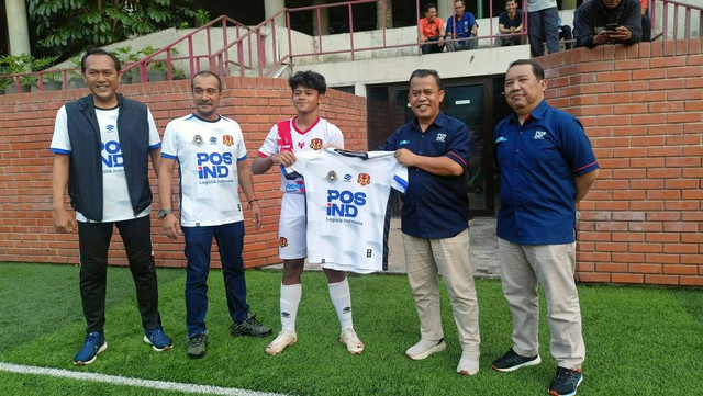 Executive Vice President PT Pos Indonesia Reg 2 Jakarta, Dino Ariyadi (kedua dari kanan), memberikan jersey baru kepada murid Java Soccer. Foto: kumparan