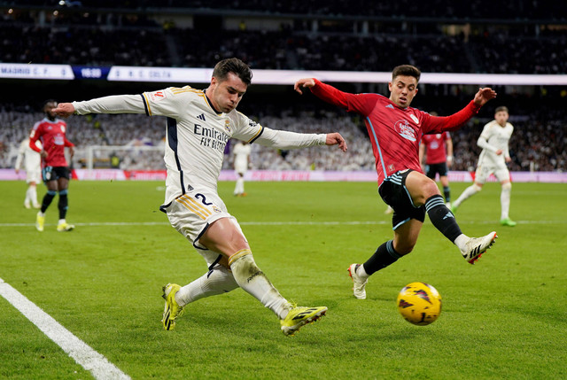 Brahim Diaz dan Fran Beltran berebut bola saat Real Madrid vs Celta Vigo dalam laga pekan ke-28 Liga Spanyol 2023/24 di Stadion Santiago Bernabeu pada Senin (11/3) dini hari WIB. Foto: REUTERS/Ana Beltran