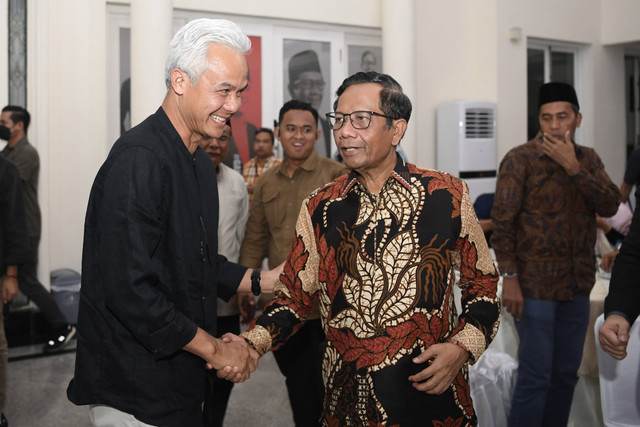 Capres dan cawapres nomor urut 3, Ganjar Pranowo (kiri) dan Mahfud MD (kanan) berjabat tangan saat akan berbuka puasa bersama relawan di Posko Pemenangan Teuku Umar, Jakarta, Rabu (20/3/2024). Foto: ANTARA FOTO/M Risyal Hidayat