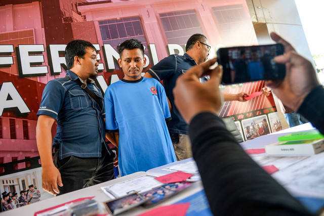 Petugas Kepolisian menggiring tersangka kasus pembunuhan Pegi Setiawan untuk dihadirkan pada konferensi pers yang digelar di Gedung Ditreskrimum Polda Jabar, Bandung, Jawa Barat, Minggu (26/5/2024). Foto: Raisan Al Farisi/ANTARA FOTO