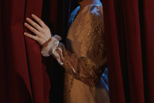 Photo by cottonbro studio: https://www.pexels.com/photo/crop-photo-of-woman-standing-behind-a-curtain-6899775/