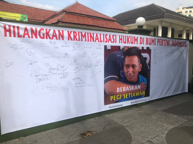 Spanduk solidaritas untuk Pegi Setiawan terbentang di depan PN Bandung. Foto: Robby Bouceu/kumparan
