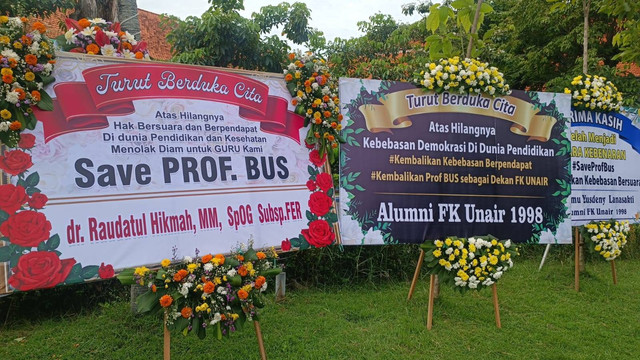 Karangan bunga bela Prof Dr Budi Santoso dr SpOG (K) yang diberhentikan sebagai dekan FK Unair terpasang di halaman depan Kampus A, Unair Surabaya, Kamis (4/7/2024). Foto: Farusma Okta Verdian/kumparan